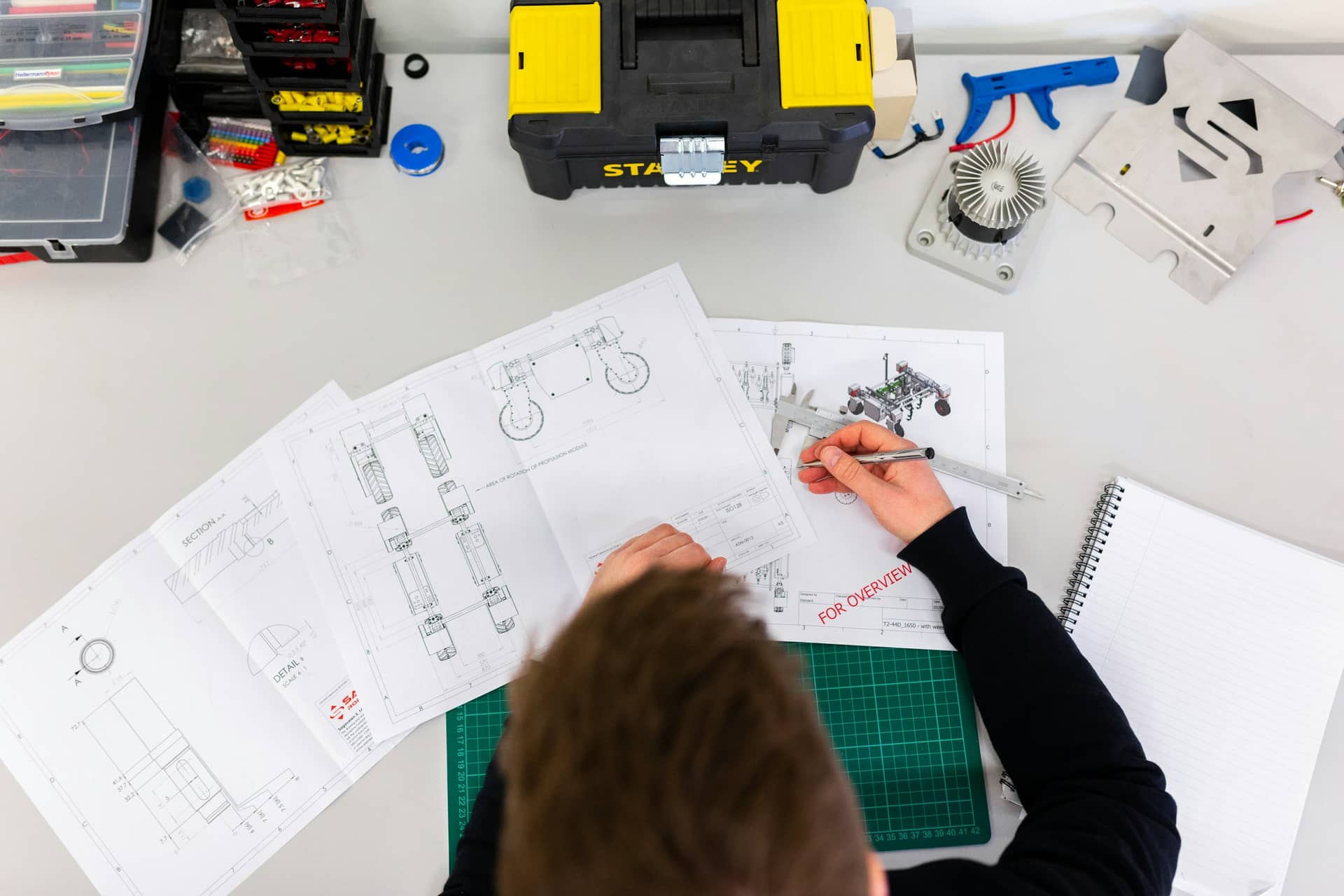 A technician working at a bench in a small business workshop